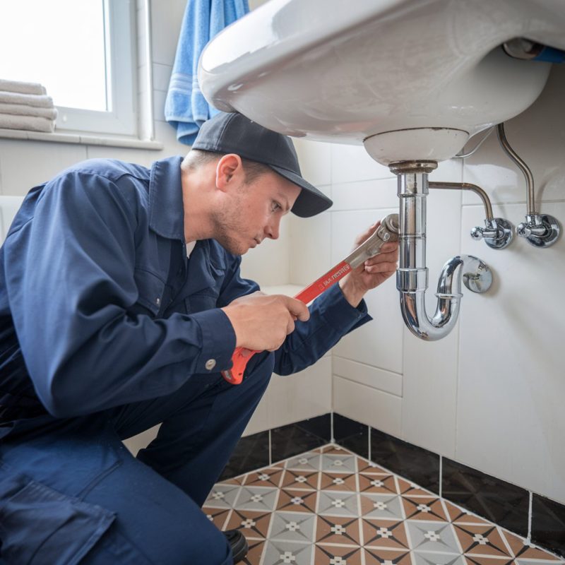 man-blue-uniform-is-using-wrench